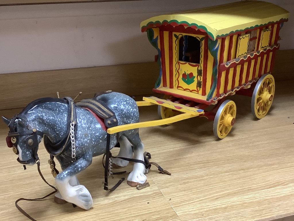 A large painted wood model Gypsy caravan and ceramic horse, overall length 85cm